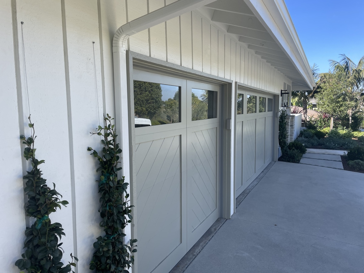 A garage door that is off its track and needs repair.